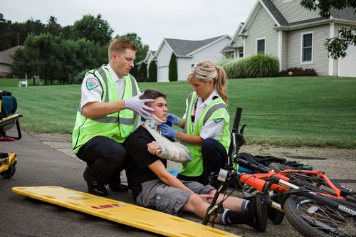 Emergency Medical Technicians (EMTs) with injured boy