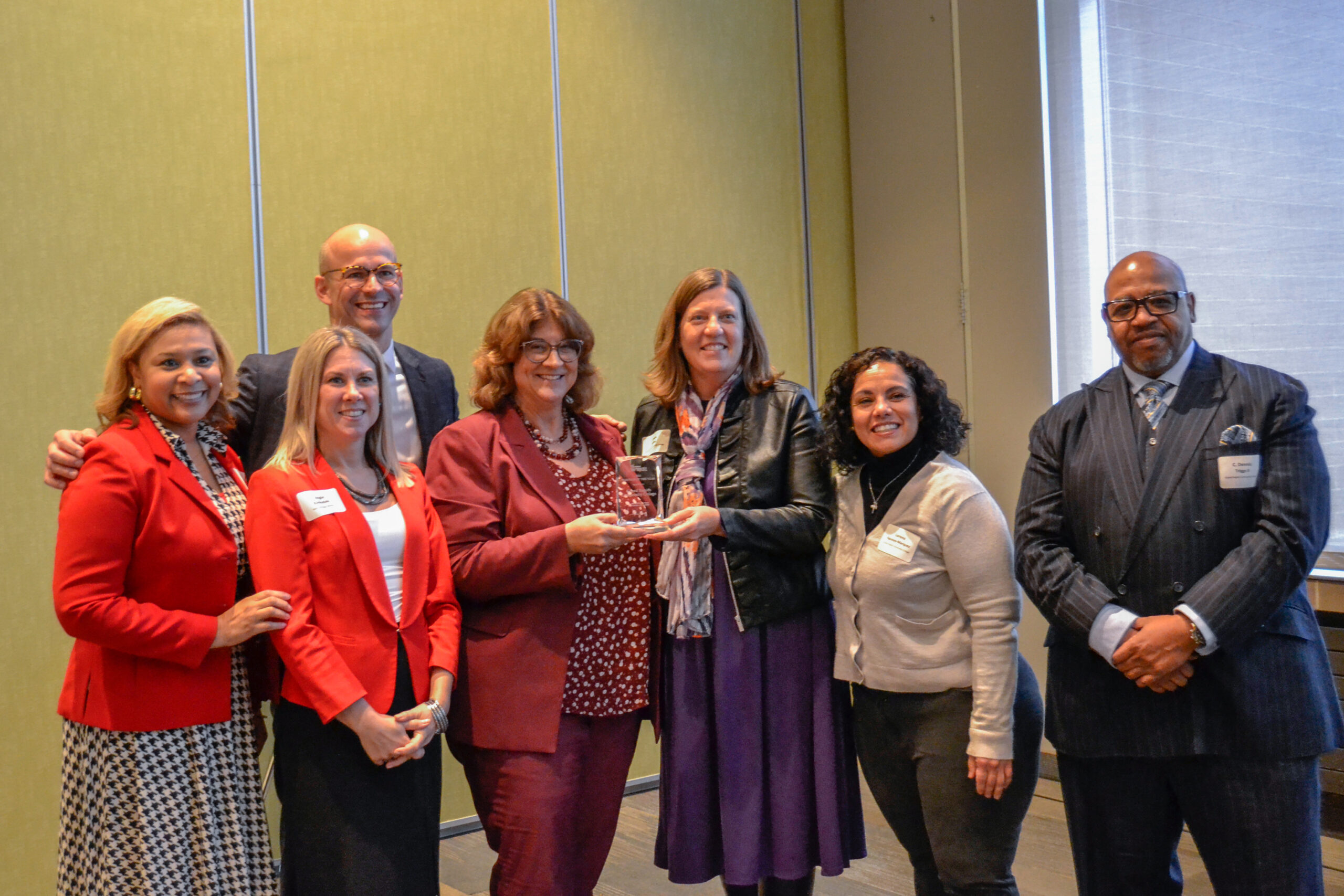 GRCC and WMW! Representatives posing for a photo with the Partner of the Year award at the 2022 WMW! Annual Meeting.