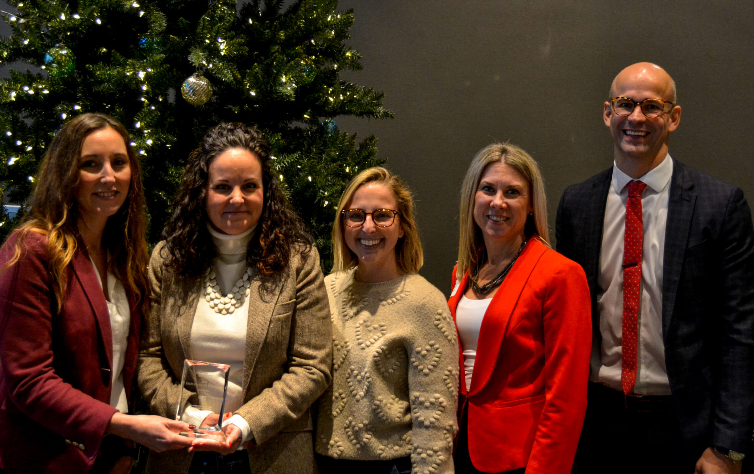 OST and WMW! representatives posing for a photo with the Employer of the Year award at the 2022 WMW! Annual Meeting.